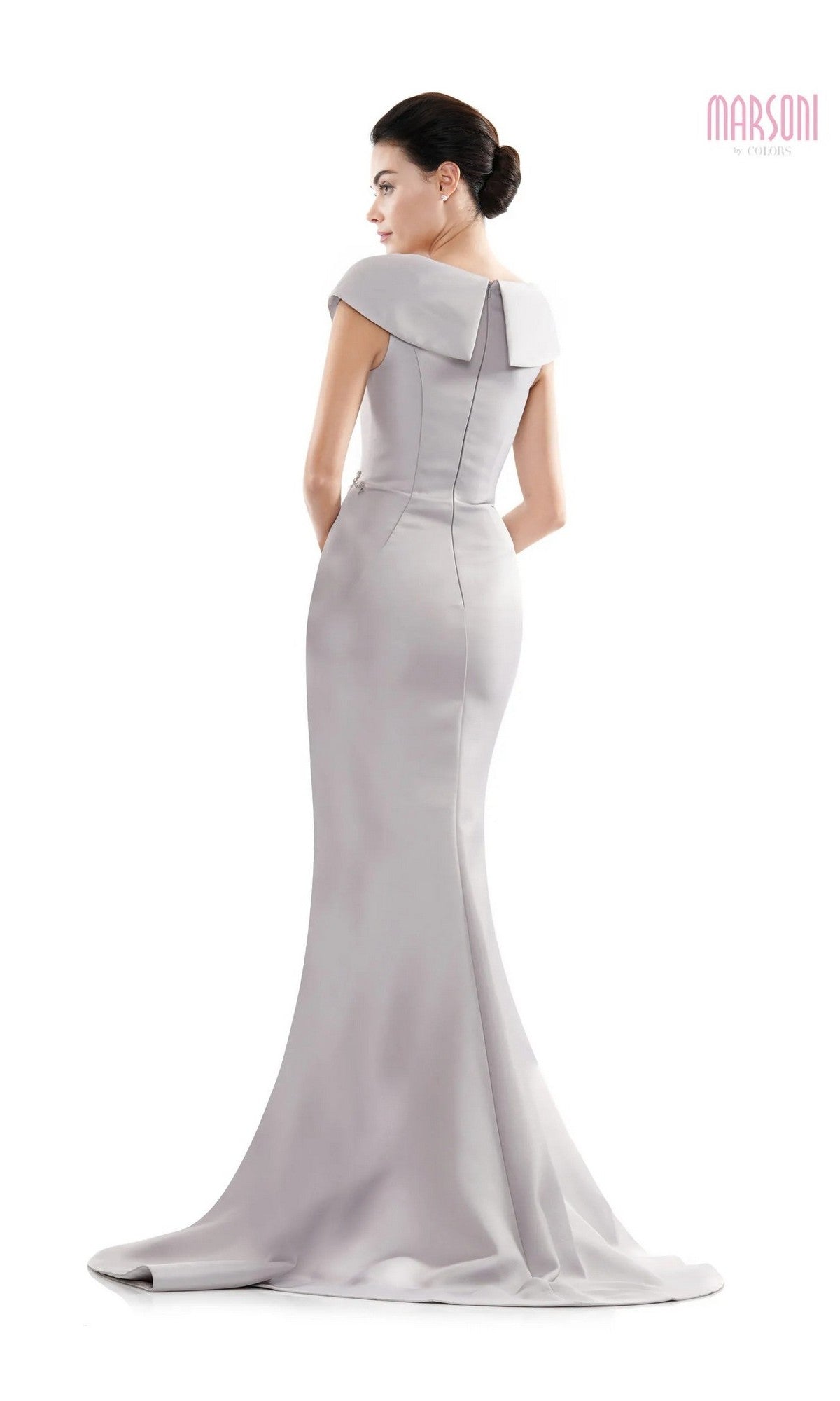 A woman faces away in the Marsoni MV1086: a fitted, floor-length light gray gown with cap sleeves, wide collar, trumpet silhouette, slight train, structured back, and subtle beaded details.